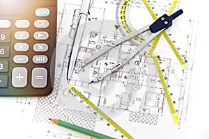 Designing a building or architecture with a ruler, pen, pencil, calculator and other equipment