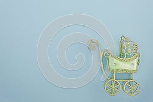 The desire to become a mother or father. Baby stroller toy on a blue