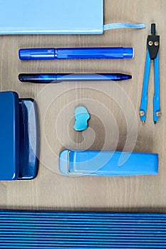 Desk with blue stationery. Wooden desk tidy with all office objects.