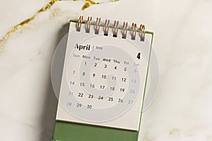 Desk calendar for April 2024 on a light background.