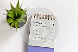 Desk calendar for February 2024 on a white background with copy space