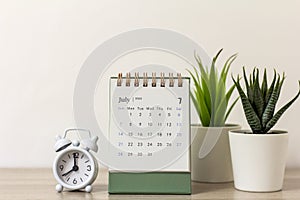 Desk calendar for July 2024 on the table with copy space