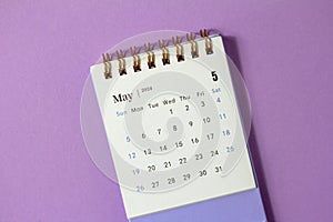 Desk calendar for May 2024 on a lilac background