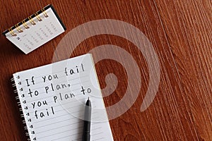 Desk calendar and notebook with quotes IF YOU FAIL TO PLAN, YOU PLAN TO FAIL