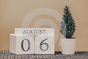 Desk calendar for use in different ideas. Summer month - August and the number on the cubes 06. Calendar of holidays on a beige