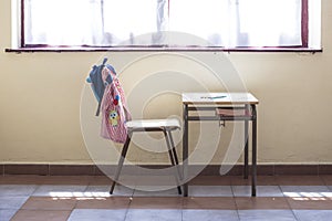 Desk and chair of a nursery school.In the photo you can see the typical material of the school year such as the backpack and the