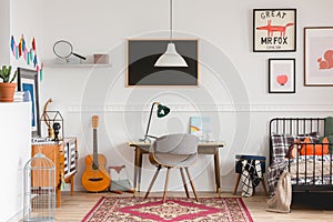 Desk and chair in workspace in vintage genderless kid room