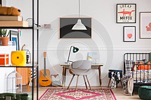 Desk and chair in workspace in vintage genderless kid room