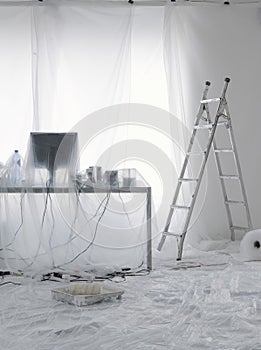 Desk And Computer Covered In Transparent Dust Sheets