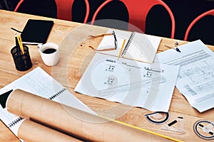 The desk of creativeness. Still life shot of a pair of spectacles placed on top an architects blueprints in a modern