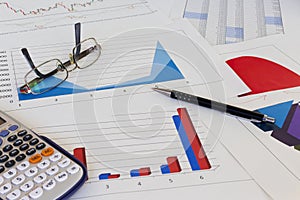 Desk with financial charts and histograms
