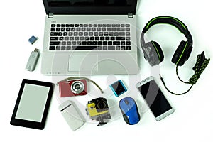 Desk with gadgets or electronic equipment for daily use, laptop computer, cell phones and digital camera