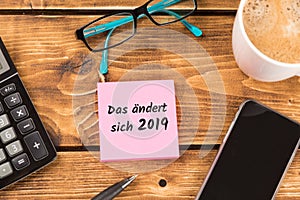 Desk with german text das ÃÂ¤ndert sich 2019?, in english that what will change in 2019