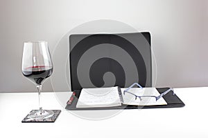 Desk with a glass of wine