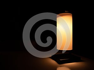 Desk lamp with release orange light like candlelight isolated on dark background