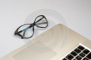 Desk with laptop, glasses and other items