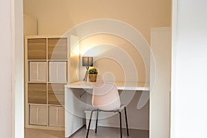 Desk in modern organized white room, home interior with, green plant and lamp