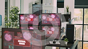 Desk with multiple monitors displaying error message on screen