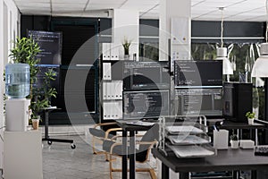 Desk with multiple pc monitors compiling terminal window