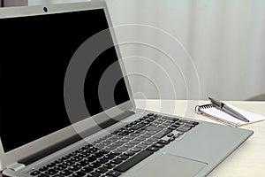 Desk with notebook on table with notepad with blurring dots and space for text