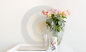 Desk and pink roses