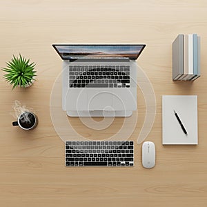 Desk setup featuring an open laptop displaying a landscape on