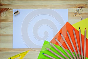 Desk with stationery, colored paper, colour pencils, pencil sharpener, ruler. Top view mock up back to school with copy space.