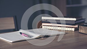 Desk for student education concept. Book for study for exam. Stack of book, diary and pen placed on white School table in the