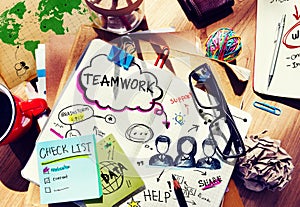 Desk with Tools and a Notebook with Ideas About Teamwork