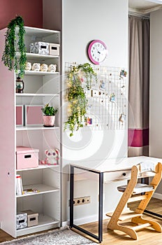 desk and wardrobe for children\'s room in white and pink colors without people