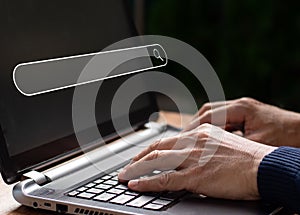 On a desk in the workplace, the businessman is working with a computer laptop. With a blank search bar, the notion is Search