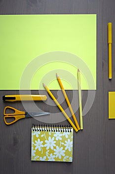 Desk with yellow stationery. Wooden desk tidy with all office objects.