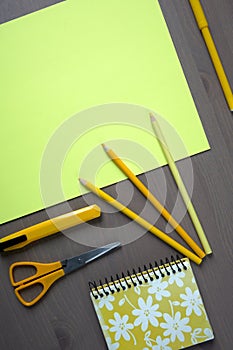 Desk with yellow stationery. Wooden desk tidy with all office objects.