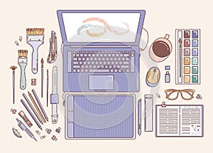 Desktop of an artist or designer, laptop, Paints and brushes, notebook, mug, graphic tablet, binder clip, stylus, flash