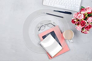 desktop with blank notebooks, pens, glasses and coffee