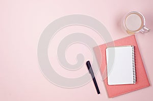 desktop with blank notebooks, pens, glasses and coffee