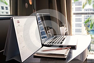 Desktop calendar 2022 on wooden desk in private office