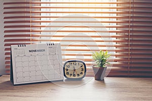 Desktop calendar, clock, and cactus placed on student wooden desk. calender for planner to plan daily appointments each day, month