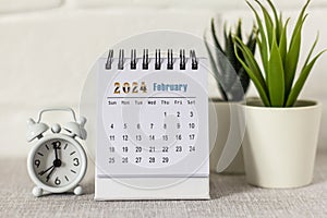 Desktop calendar for February 2024 on the table.