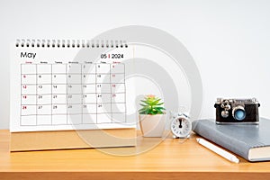 Desktop Calendar for May 2024 year and vintage camera with diary for Planner to plan timetable