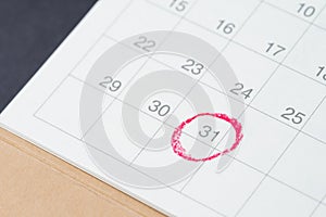Desktop calendar with red circle on last day, 31 important resignation date, end of month, reminder and schedule or project plan