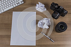 Desktop with camera and blank sheet