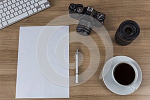 Desktop with camera blank sheet and coffee