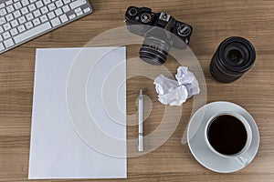 Desktop with camera blank sheet and coffee