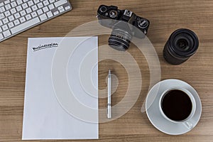 Desktop with camera blank sheet and coffee photo