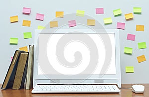 Desktop computer with blank white screen on the desk table.