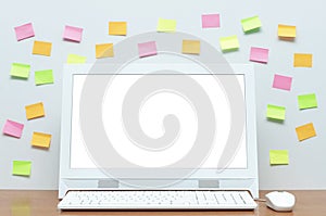 Desktop computer with blank white screen on the desk table.