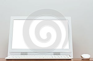Desktop computer with blank white screen on the desk table.