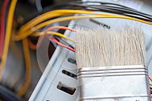 Desktop computer dust cleaning with tassel. computer power wires