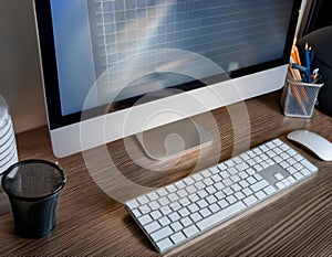 Desktop computer setup, including accessories like keyboard and mouse, representing office work, productivity, and tech